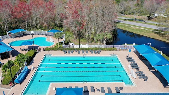 view of swimming pool featuring a water view