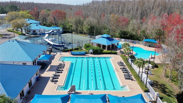 view of pool with a patio area and a water slide