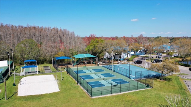 view of tennis court with a lawn