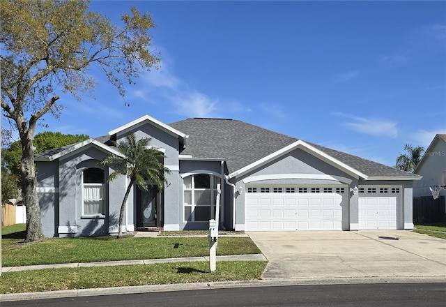 ranch-style house featuring a shingled roof, a front lawn, concrete driveway, stucco siding, and a garage