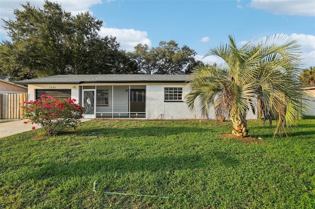 single story home with a garage and a front lawn