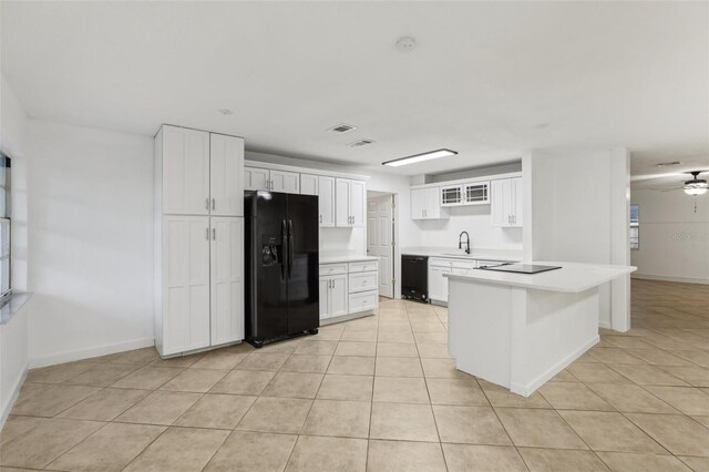 kitchen with white cabinetry, sink, black appliances, light tile patterned floors, and ceiling fan