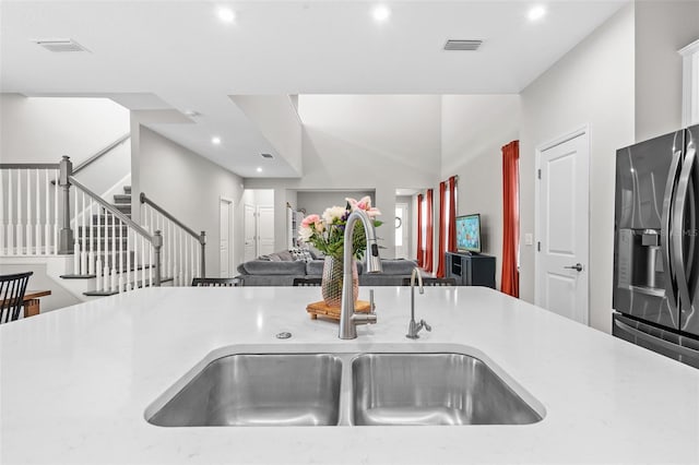 kitchen featuring stainless steel fridge and sink