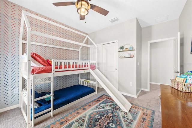 carpeted bedroom featuring a closet and ceiling fan