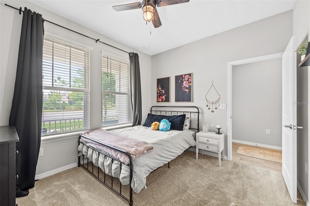 bedroom featuring ceiling fan and light carpet