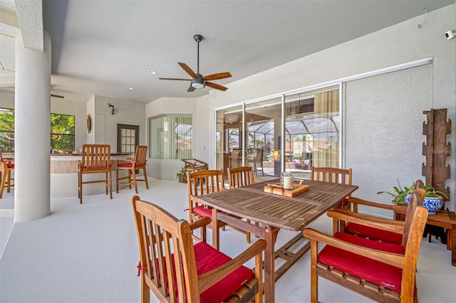 carpeted dining area featuring ceiling fan