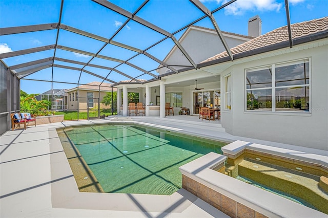 view of pool with ceiling fan, a lanai, an outdoor bar, a patio area, and an in ground hot tub