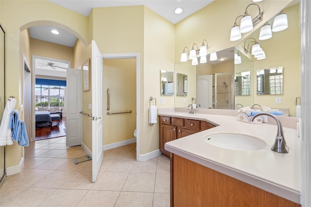 bathroom featuring tile patterned flooring, vanity, toilet, and an enclosed shower