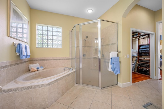 bathroom featuring tile patterned floors and separate shower and tub