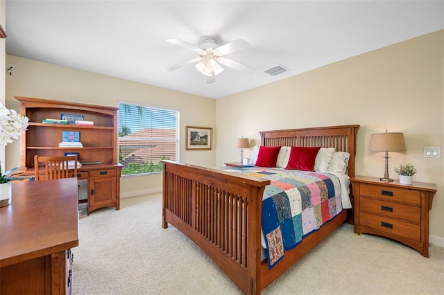 bedroom with ceiling fan and light carpet