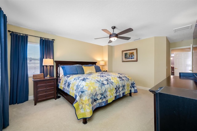 bedroom with ceiling fan and light carpet