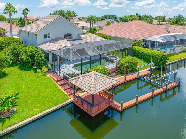 drone / aerial view featuring a water view and a residential view