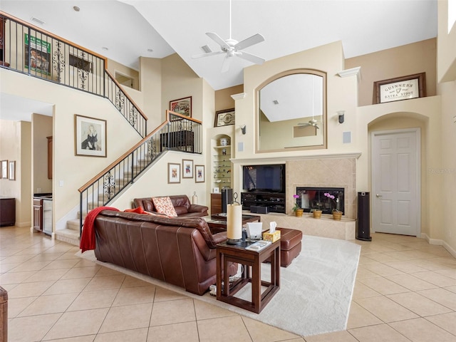 5510 E Longboat Blvd, Tampa, FL 33615 - living area featuring light tile patterned flooring, stairway, a ceiling fan, a high ceiling, and baseboards
