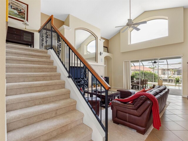 5510 E Longboat Blvd, Tampa, FL 33615 - stairway with a ceiling fan, tile patterned flooring, and high vaulted ceiling