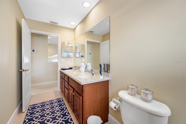 5510 E Longboat Blvd, Tampa, FL 33615 - bathroom with toilet, visible vents, a sink, tile patterned flooring, and double vanity