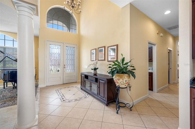5510 E Longboat Blvd, Tampa, FL 33615 - foyer entrance featuring decorative columns, light tile patterned floors, baseboards, a towering ceiling, and recessed lighting