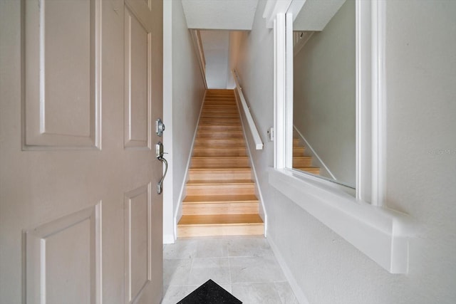 stairs featuring light tile floors