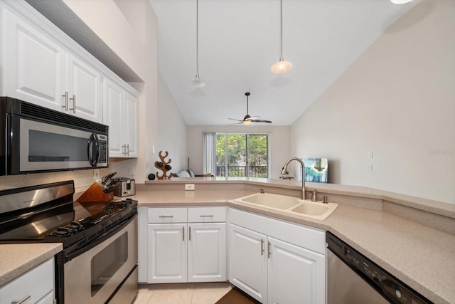 kitchen featuring ceiling fan, stainless steel appliances, high vaulted ceiling, sink, and white cabinets