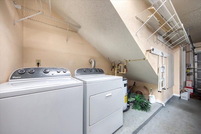 washroom featuring a textured ceiling and washing machine and dryer