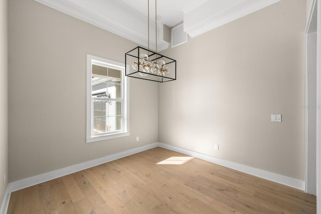 unfurnished dining area with hardwood / wood-style floors and an inviting chandelier