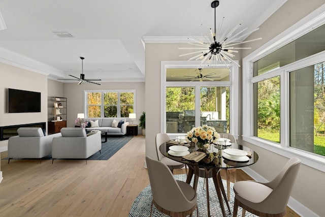 sunroom / solarium featuring an inviting chandelier