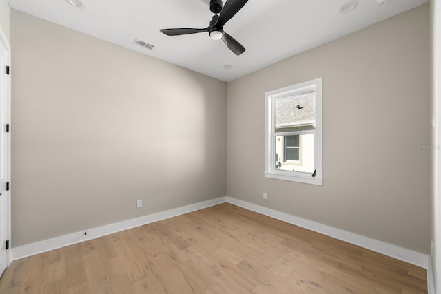 empty room with ceiling fan and light wood-type flooring