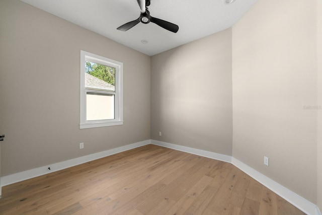 spare room featuring light wood-type flooring and ceiling fan