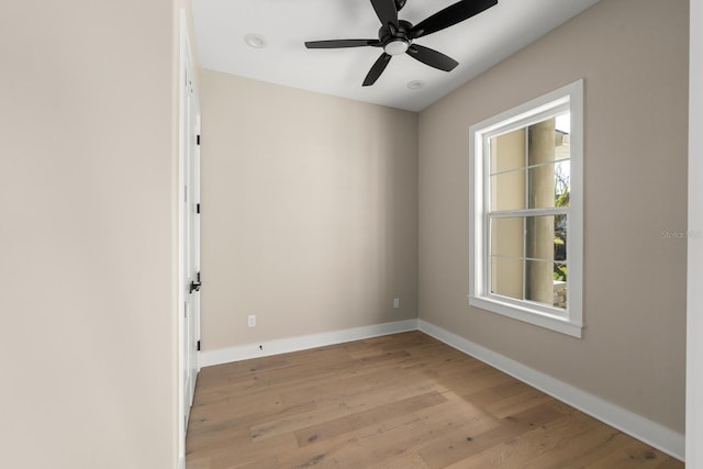 spare room featuring light hardwood / wood-style floors and ceiling fan