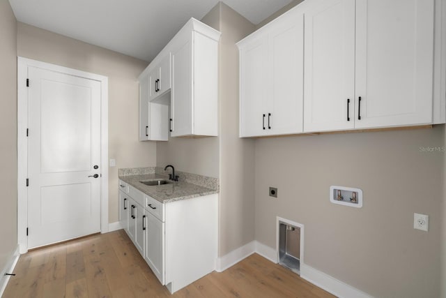 laundry area featuring cabinets, sink, hookup for a washing machine, light wood-type flooring, and hookup for an electric dryer