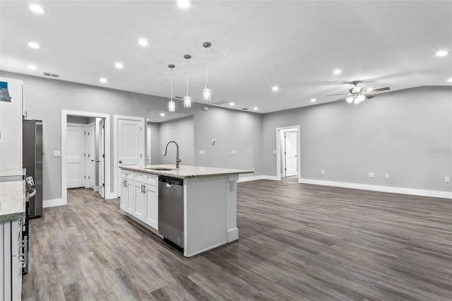 kitchen with pendant lighting, sink, white cabinets, light stone counters, and stainless steel appliances