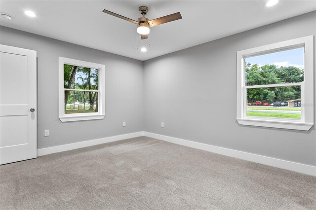 carpeted empty room featuring ceiling fan