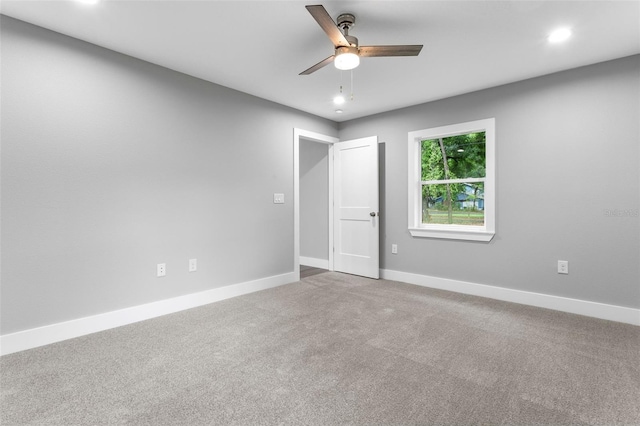 unfurnished room featuring ceiling fan and carpet flooring