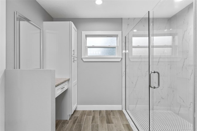 bathroom featuring vanity and a shower with door