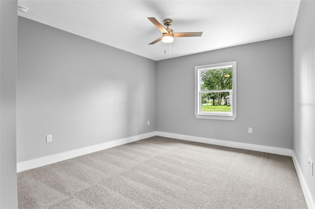 spare room featuring a textured ceiling, ceiling fan, and carpet flooring