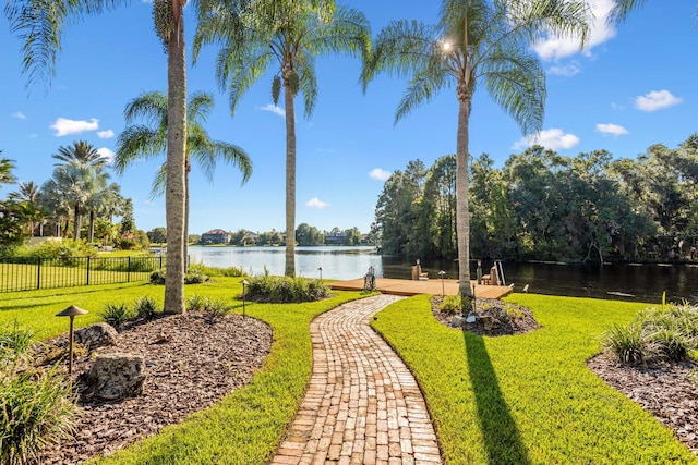 exterior space featuring a lawn and a water view