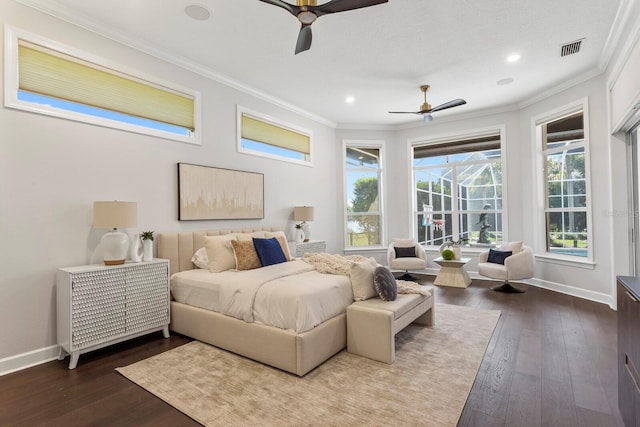 bedroom featuring ornamental molding, ceiling fan, and dark wood-type flooring