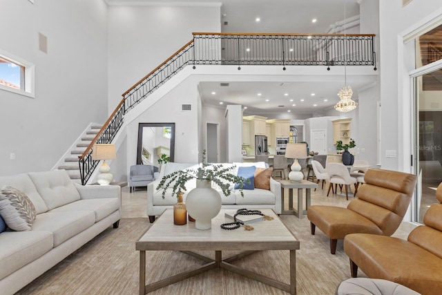 living room featuring a towering ceiling and crown molding