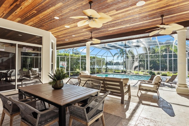 sunroom with wood ceiling, ceiling fan, a swimming pool, and plenty of natural light