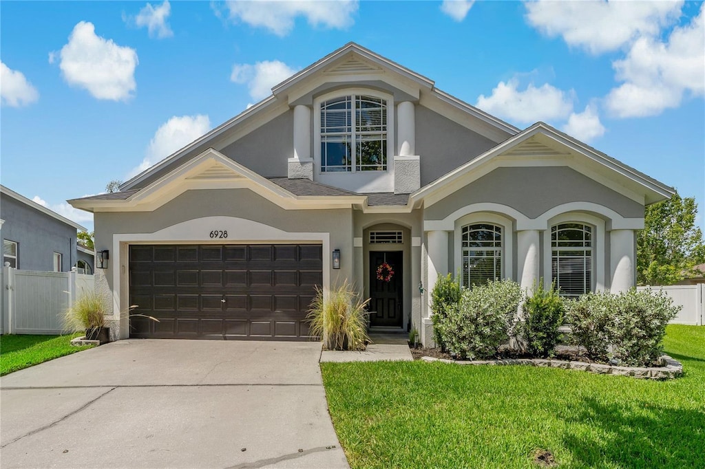 view of front of house with a front lawn and a garage