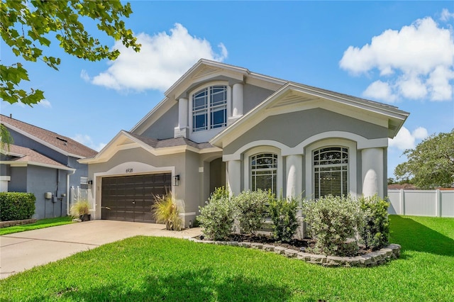 view of front of home with a front yard and a garage