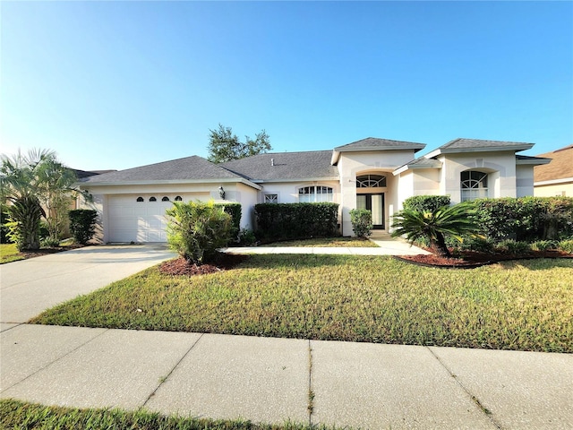 view of front of home featuring a garage and a front yard