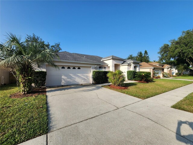 single story home with a garage and a front yard