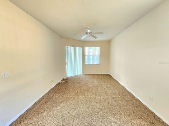 carpeted spare room with ceiling fan