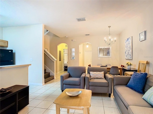 2705 Bushman Dr, Kissimmee, FL 34746 - living area with arched walkways, a chandelier, light tile patterned flooring, and stairway