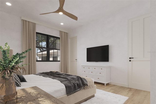 bedroom with ceiling fan and light hardwood / wood-style flooring