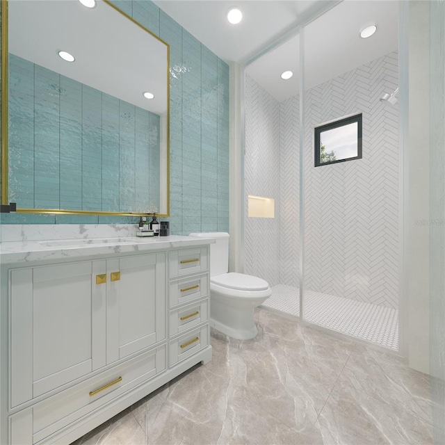 bathroom featuring toilet, vanity, tile walls, and tiled shower