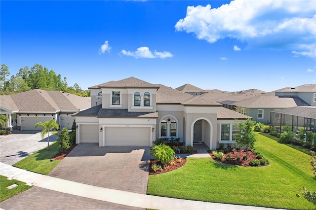 view of front of home with a garage and a front lawn