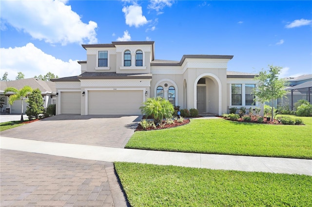 mediterranean / spanish home with a garage and a front yard