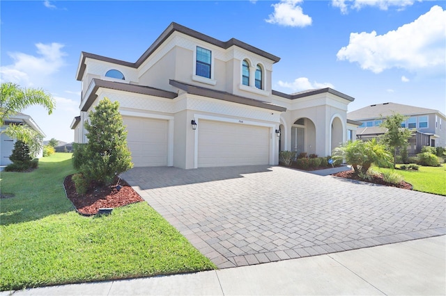 view of front of home featuring a garage and a front lawn