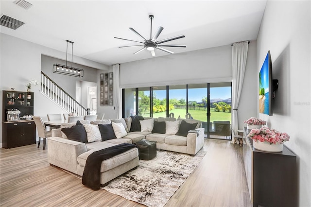 living room featuring ceiling fan and hardwood / wood-style floors